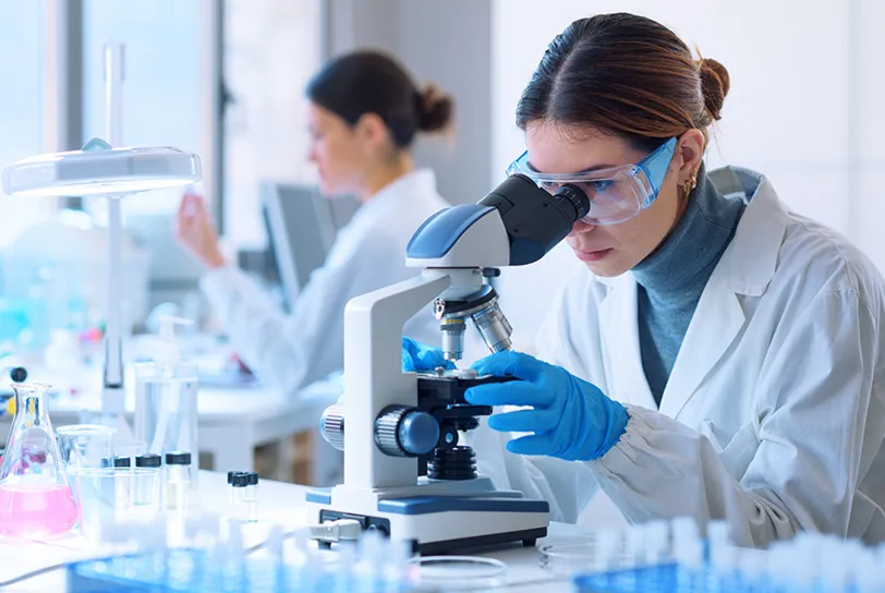 woman scientist looking into a microscope