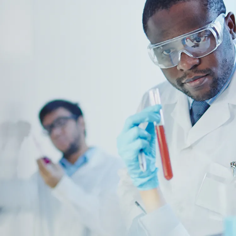 Mand and woman scientists in lab looking at test tube
